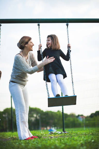 istock Happy young girl on swing 671327116