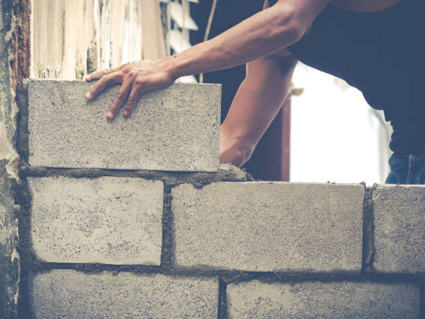 istock Brick Builders Are Building Walls 671328208