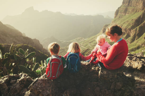 istock mother with three kids hiking in mountains 671330892