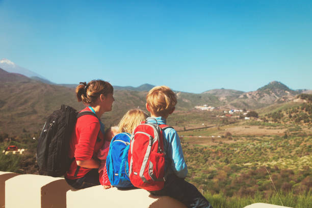 istock mother with three kids travel in mountains 671330972