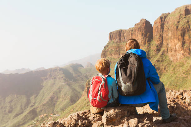 istock father and son hiking in mountains 671331130