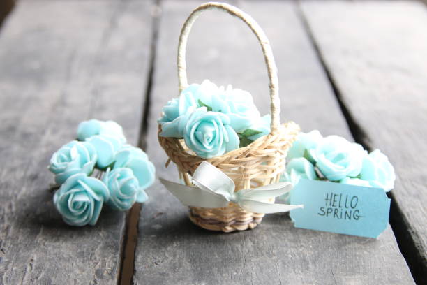 istock hello spring tag and flowers in a small basket 671334598