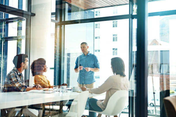 istock Briefing his team in the boardroom 671335446