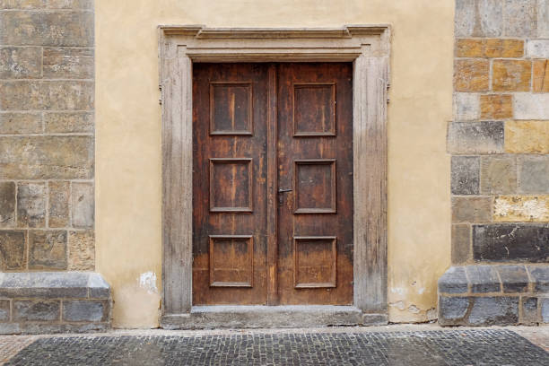 wooden double door with rectangle door frame in a stone wall