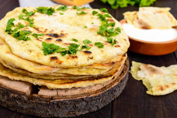 istock Thin flatbread - traditional Asian bread on a dark wooden background. 671342318