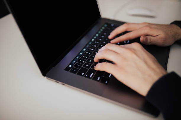 istock No facial regocnition, hands on laptop 671342832