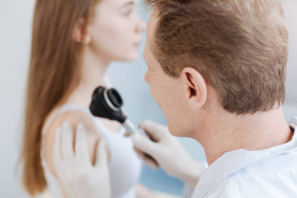 istock Peaceful young patient getting skin analysis in the clinic 671348186