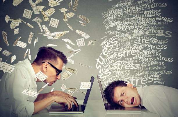 istock Stressed man working on laptop next to man under money rain. 671353014