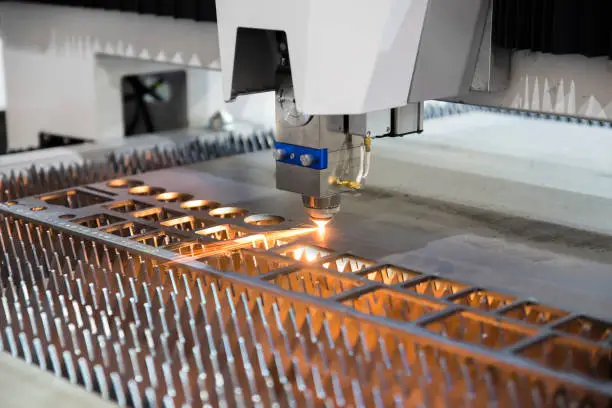 Photo of High precision CNC gas cutting metal sheet working in industry factory. Smart industry factory concept.