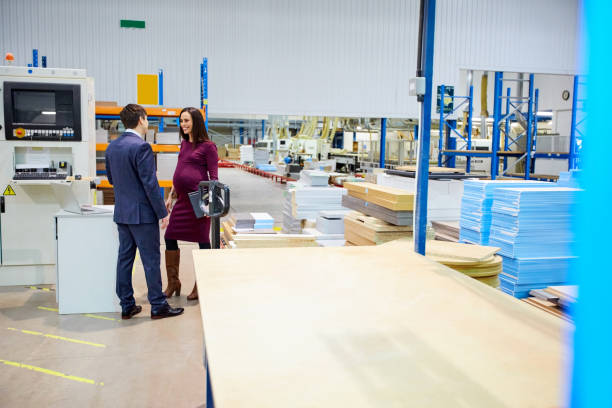 istock Business colleagues having a discussion in factory 671360210