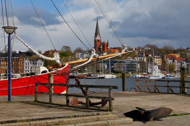 Flensburg Harbor, Germany Historic sailing boat at the harbor of Flensburg, Germany. Dramatic clouds in April. Photography taken with polarizing filter. gewitter stock pictures, royalty-free photos & images