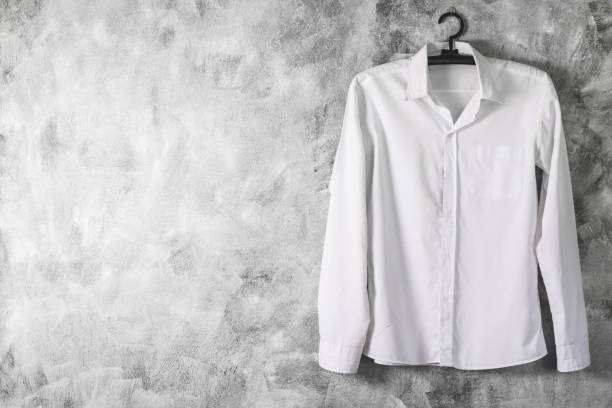 istock White shirt with long sleeves on grunge background. Free space for text 671362164