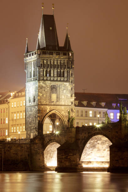 istock Charles bridge at night with water reflection, Prague, Czechia. 671364892