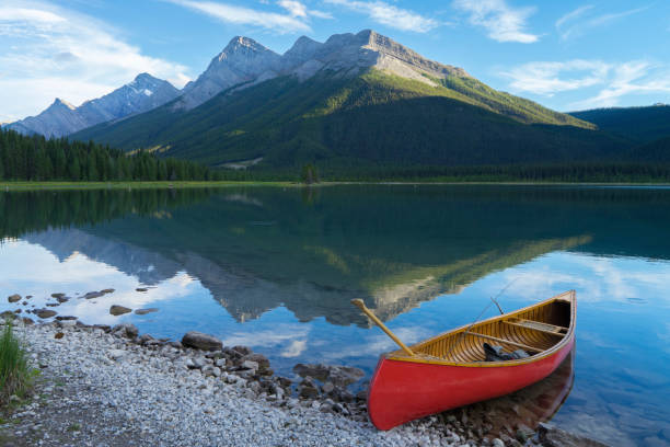 istock Scenic with canoe and paddle, at mountain lake 671365471
