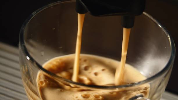 istock coffee machine pouring espresso in cup extremely close-up 671371232
