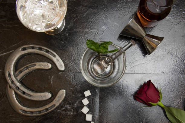 Lay flat of deconstructed mint julep Lay flat overhead of bar countertop with deconstructed elements of Kentucky Derby mint julep with horse shores and red rose. kentucky derby stock pictures, royalty-free photos & images