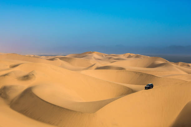 istock Dangerous jeep - safari through sand dunes 671372742
