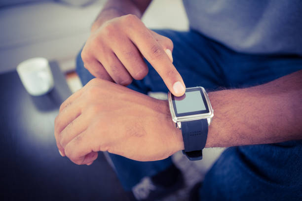 istock Close-up of man using smart watch 671372946