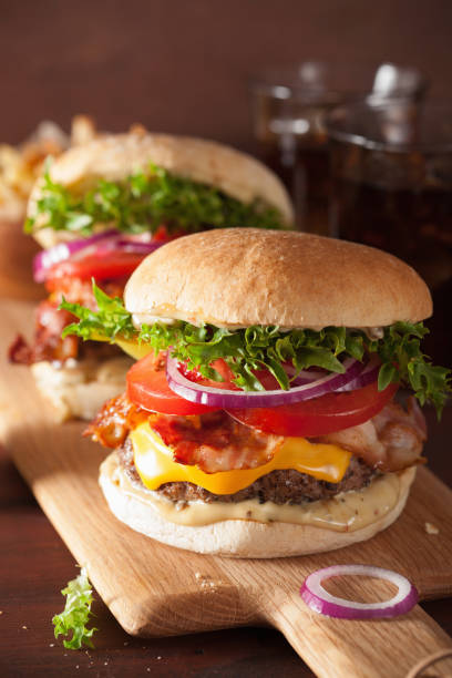 istock bacon cheese burger with beef patty, tomato and onion 671375800