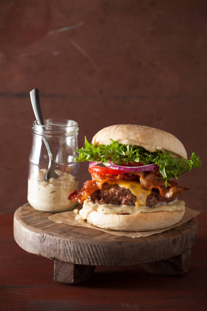 istock bacon cheese burger with beef patty, tomato and onion 671379684