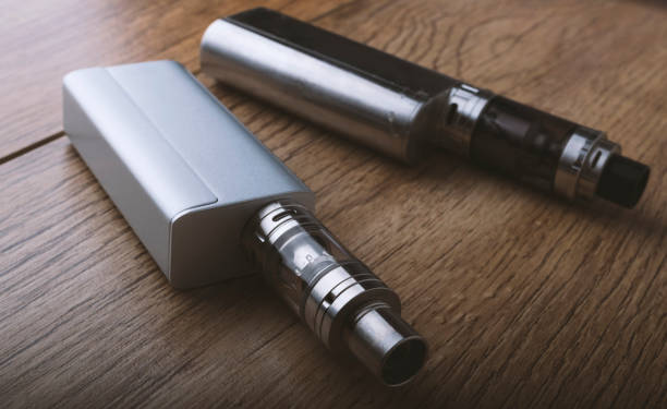 istock vape pen, mod, e cigarette, e-cig, on a wooden background. 671382586