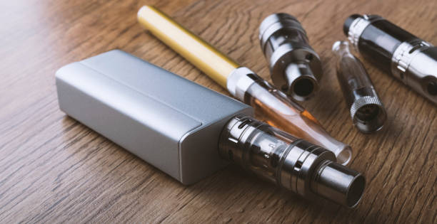 istock vape pen, mod, e cigarette, e-cig, on a wooden background. 671382632