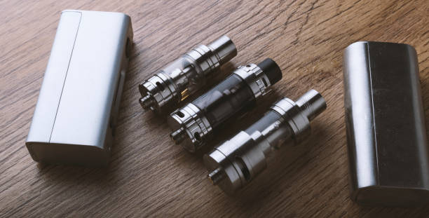 istock vape pen, mod, e cigarette, e-cig, on a wooden background. 671382792