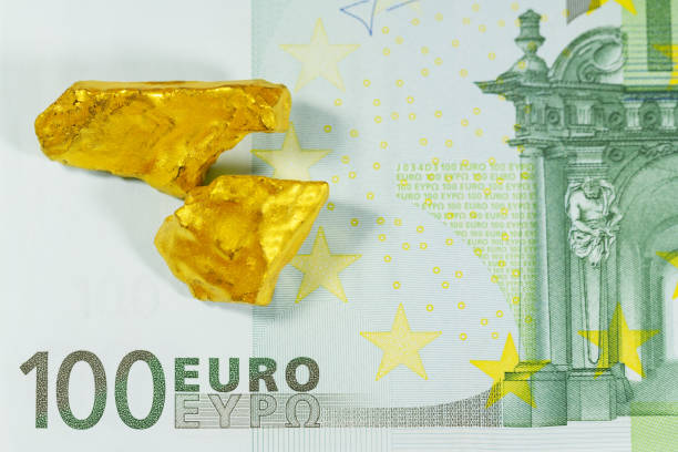 istock Golden nuggets on euro banknotes close up 671382850