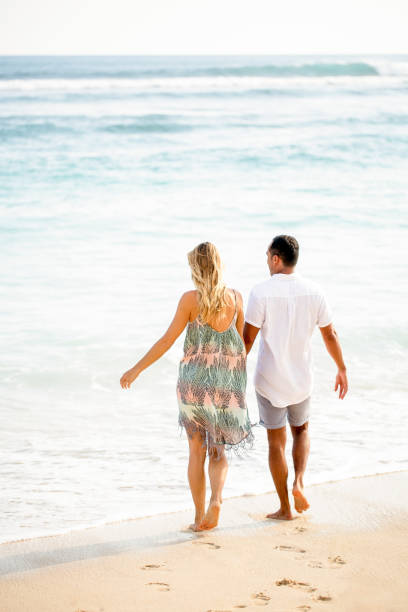 istock Couple Strolling on Seaside in Summer 671386168