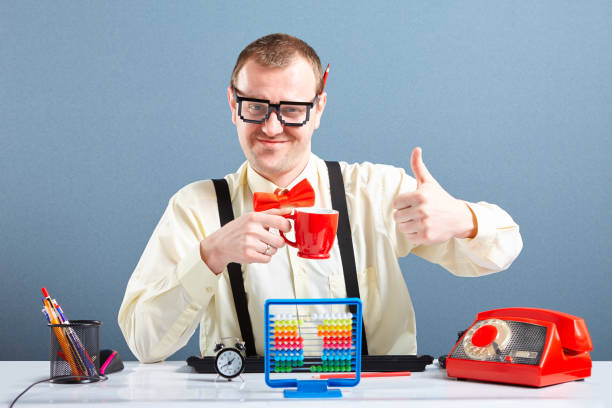 Successful looking nerd guy using abacus stock photo