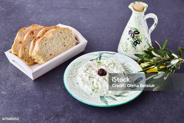 Greek Traditional Sauce Tzatziki With Olives Olive Oil Jar Lemon And Bread On A Grey Abstract Background Healthy Eating Concept Stock Photo - Download Image Now