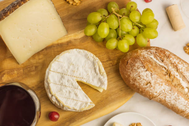 istock Red wine, cheese, bread and grapes, overhead photo 671400288
