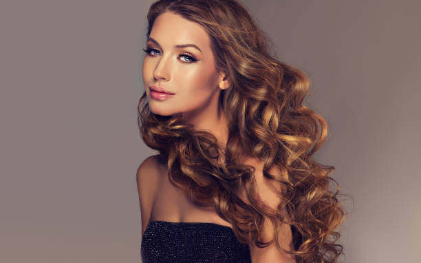 istock Brunette with voluminous, shiny and curly hairstyle. 671400496