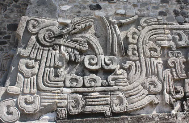Bas-relief carving with of a Quetzalcoatl, pre-Columbian Maya civilization, Temple of the Feathered Serpent in Xochicalco, Mexico. UNESCO world heritage site