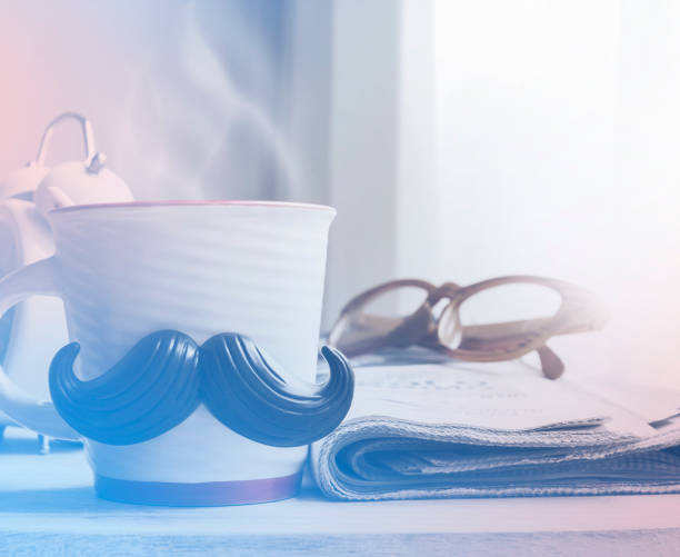 istock Cup with mustache on wooden table for fathers day concept 671415476