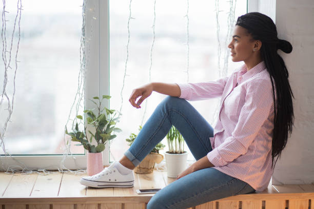 istock Calm young woman resting and dreaming at home 671417348