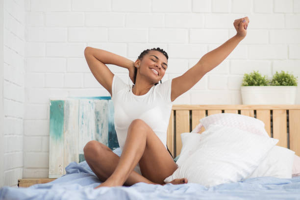 istock Happy African woman waking up 671418268