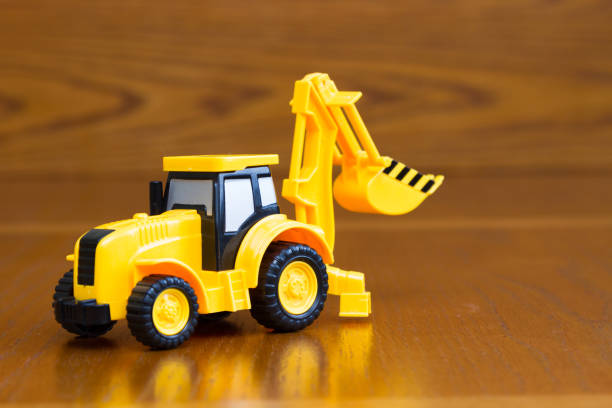 istock Children's tractor yellow on a brown background 671418806