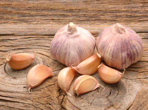 istock Garlic on the wooden background 671422258