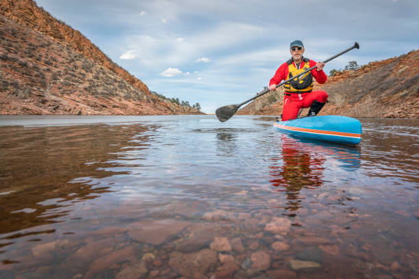 istock winter stand up paddling in Colorado 671424728