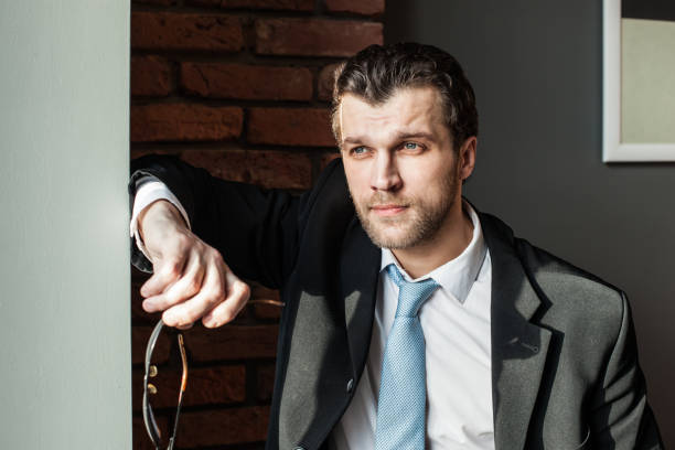 istock Young businessman looking away thoughtfully 671425616