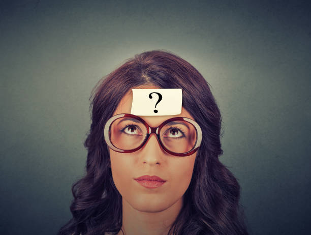 istock thinking woman with question mark on gray wall background 671427140