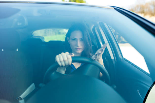 istock Woman driving a car 671427780