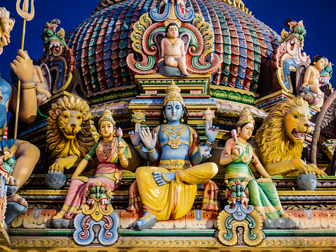 Hindu Gods sculptures in the roof of the  Sri Mariamman Temple in Chinatown Singapore