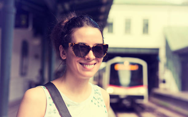 istock Closeup portrait young woman standing on subway platform waiting approaching train 671431408