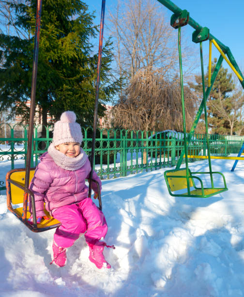 istock child outdoor in park at winter day 671436438