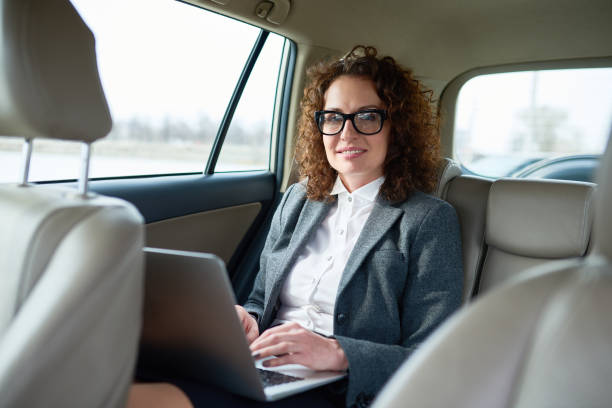 istock Successful woman inside luxury car 671436456
