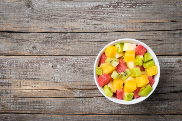 istock Fresh fruit salad on an old wooden background 671454626