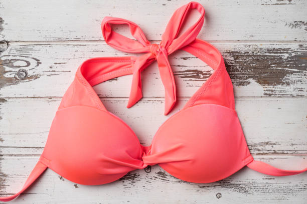 istock Swimsuit on an old wooden table 671454788
