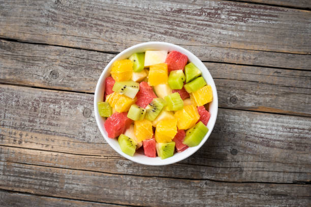 istock Fresh fruit salad on an old wooden background 671455122